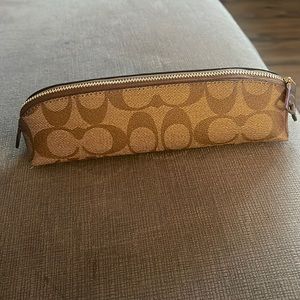 Coach makeup bag never used can be used for eye pencils or change small carry on